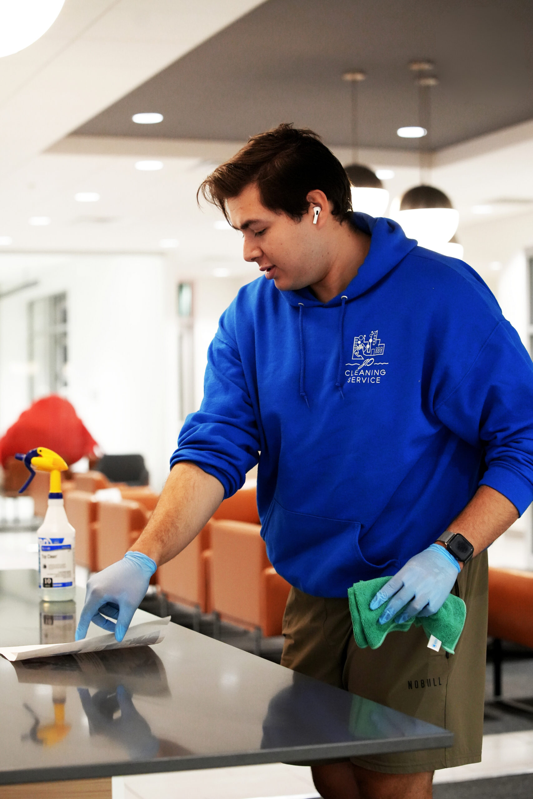 Man in blue shirt cleaning countertop