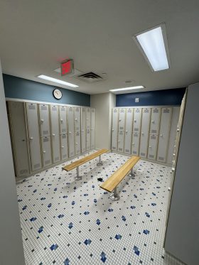 locker room with gray lockers and benches