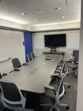 Conference table with chairs and TV